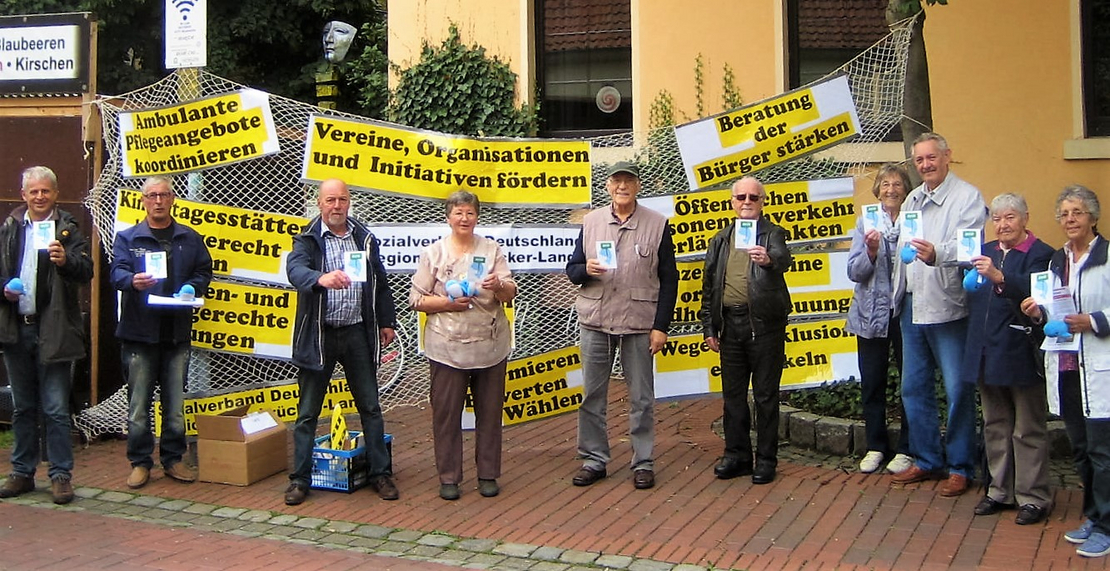 SoVD-Mitglieder mit Handzetel und Forderungs-Plakaten